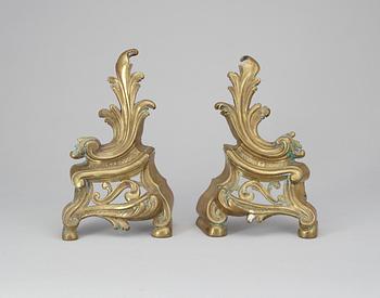 477. A pair of brass fire dogs. Rococo style.