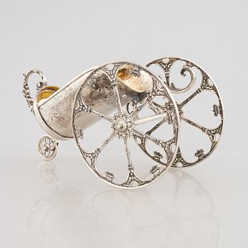 A silver bottle holder with wheels, 20th Century.