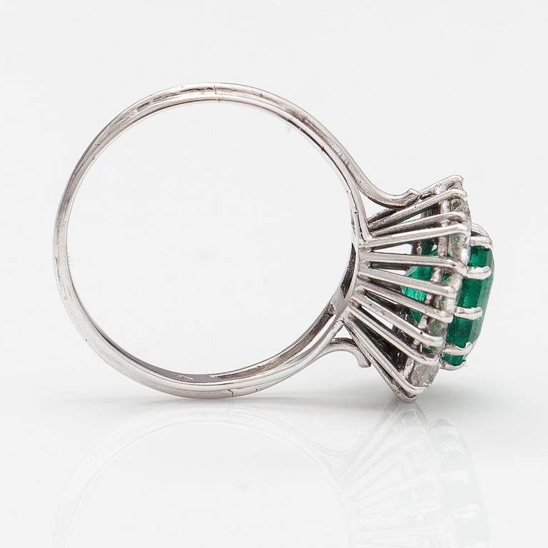 An 18K white gold ring with diamonds ca. 1.56 ct in total and an emerald ca. 2.70 ct according to certificate.