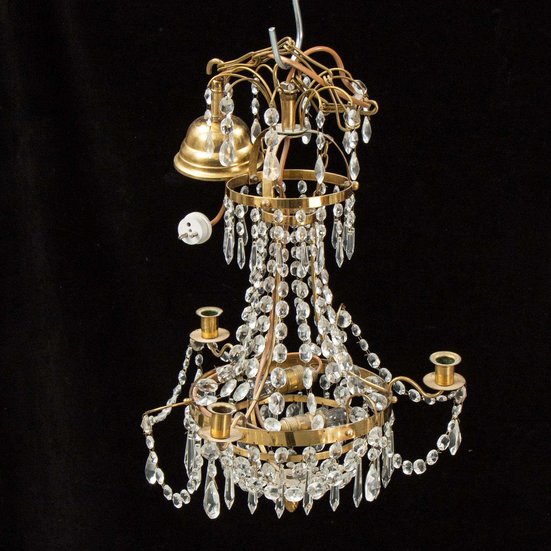 A small Swedish 20th century empire style chandelier for three candles.