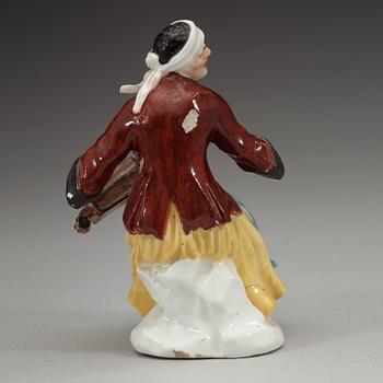 A porcelain figure of a begger playing an instrument, 1740's, presumably Meissen.