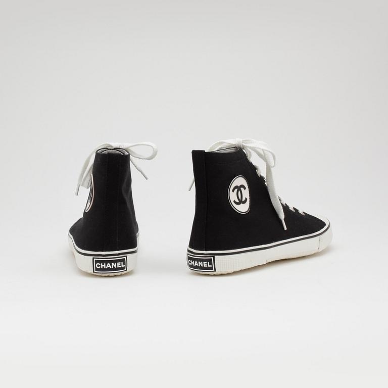 CHANEL, a pair of black canvas sneakers.