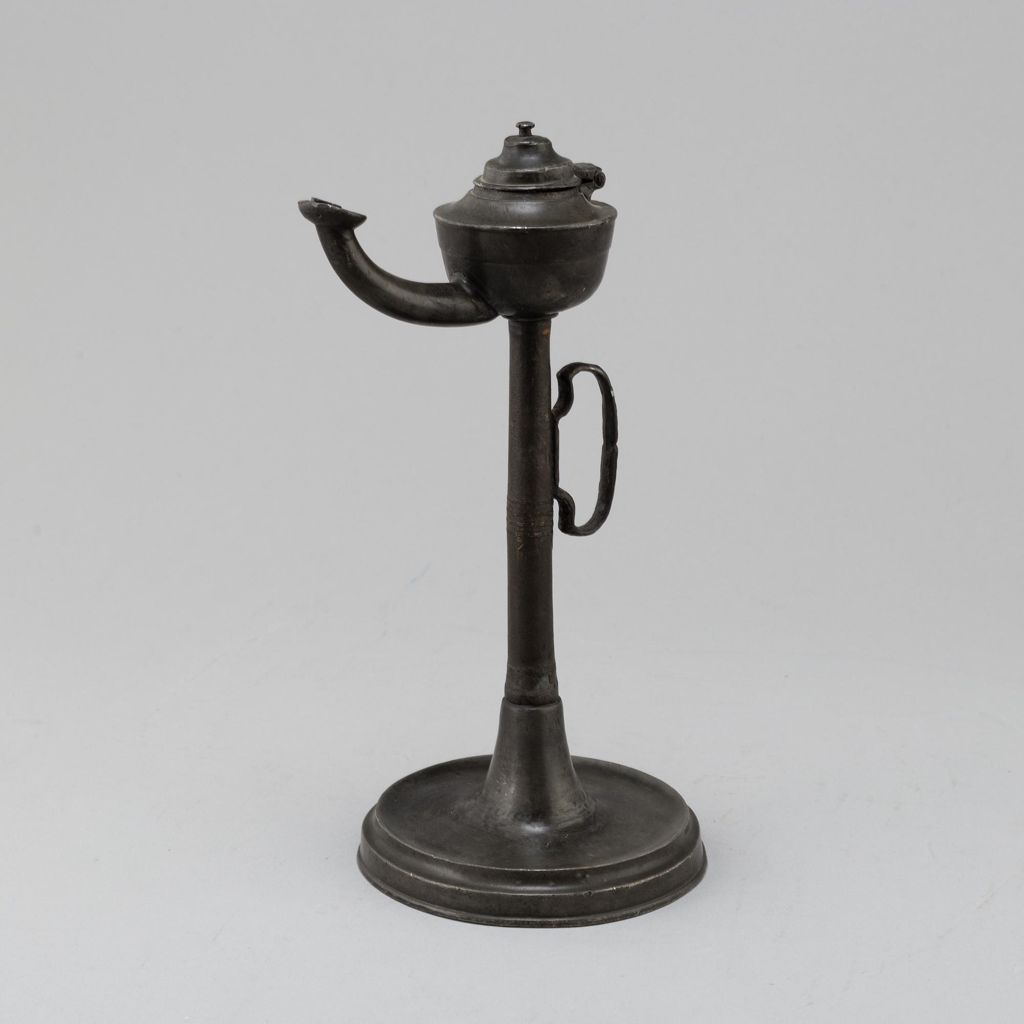 An 18th century pewter oil lamp.