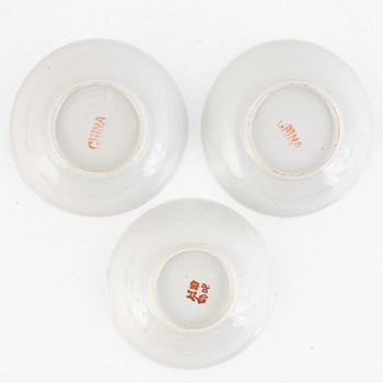 A group of three Chinese enamelled porcelain cups with covers and stands, three small dishes, 20th century.