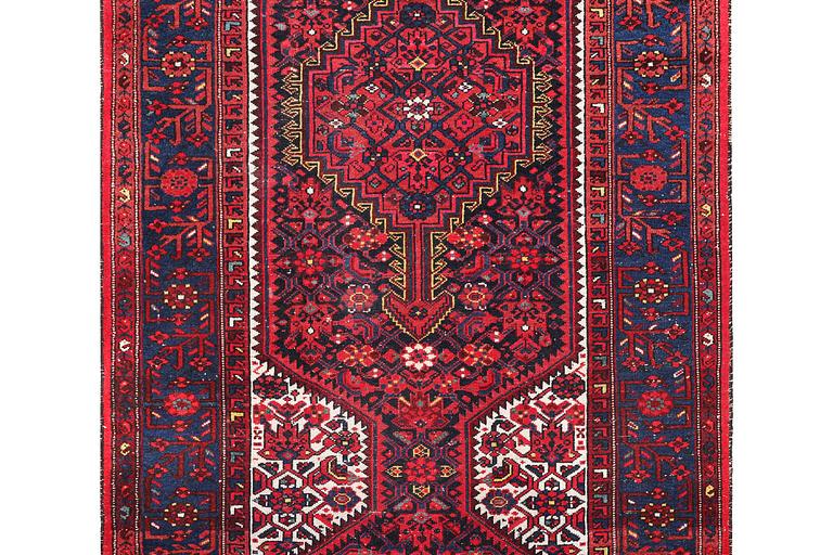 A Hosseinabad carpet, c. 391 x 135 cm.