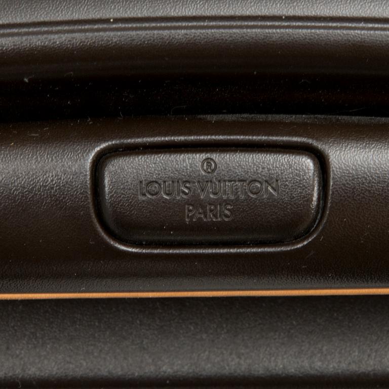 A Monogram Canvas Pégase 65 Suitcase with a Protective Cover.