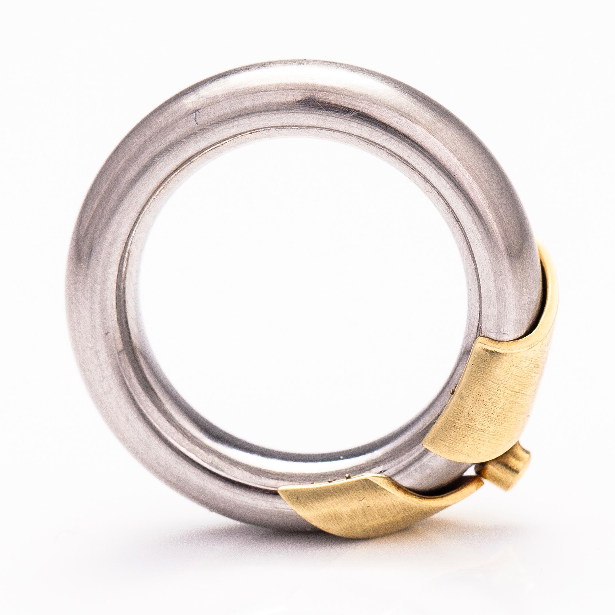 A steel and gold ring with a diamond ca. 0.015 ct.