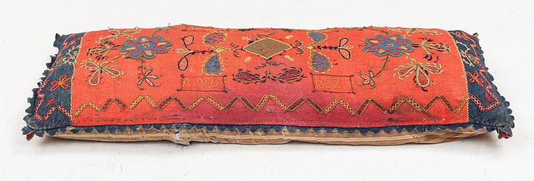 An embroidered carriage cushion, 100 x 50 cm, dated 1852.