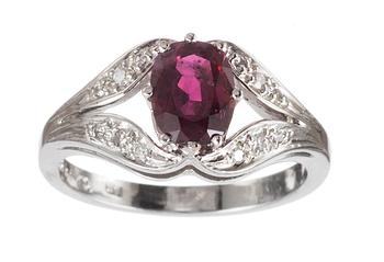 635. RING, set with ruby and small diamonds.
