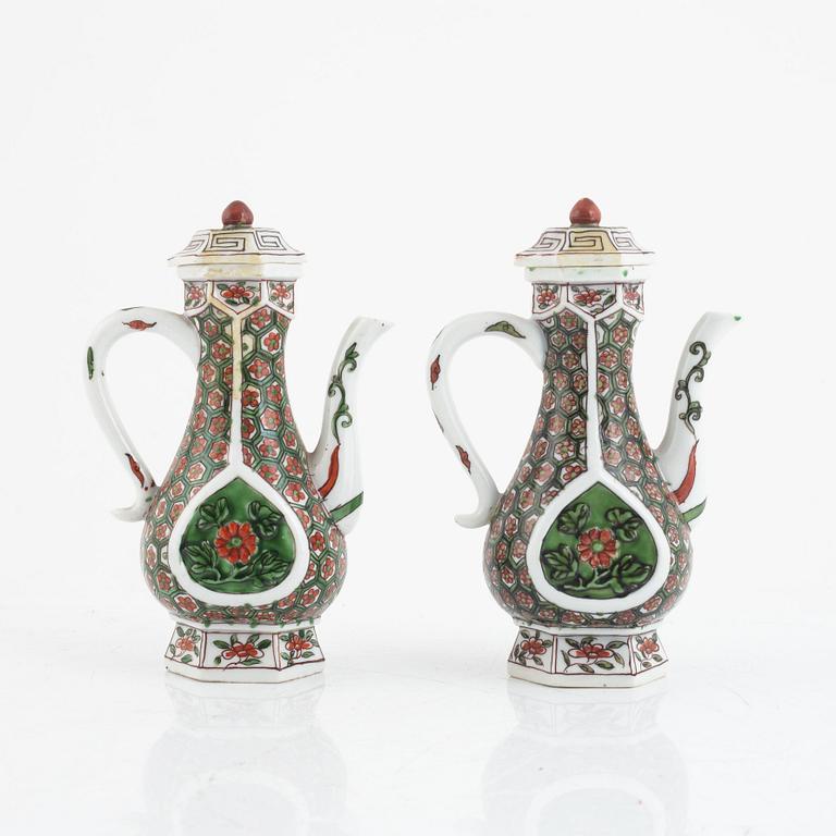 A pair of famille verte ewers and covers, 20th century.