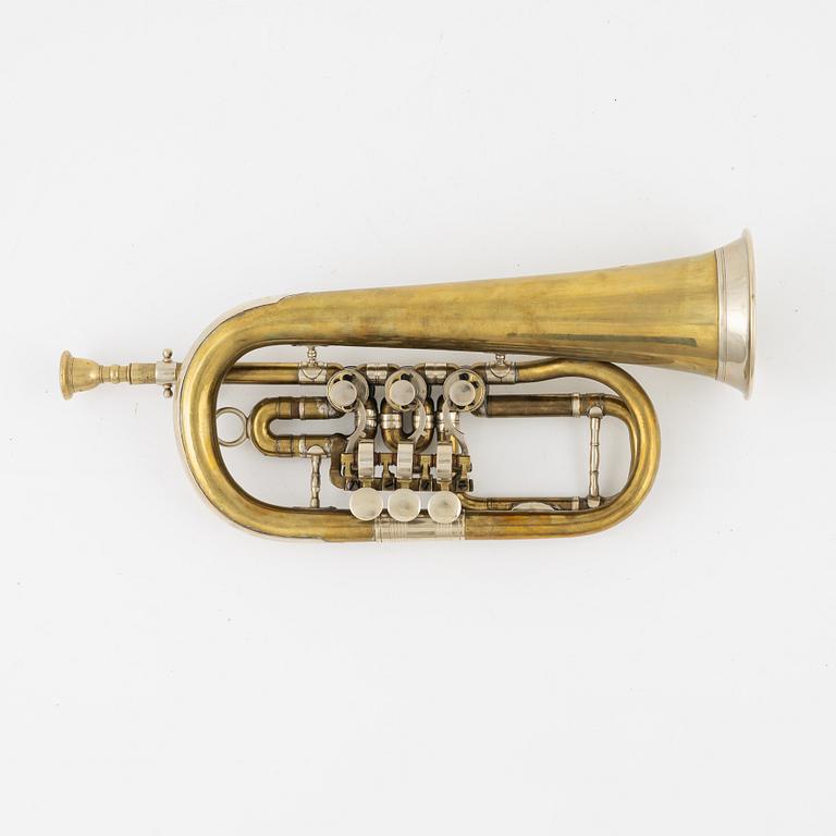 A brass cornet, marked with a crown.