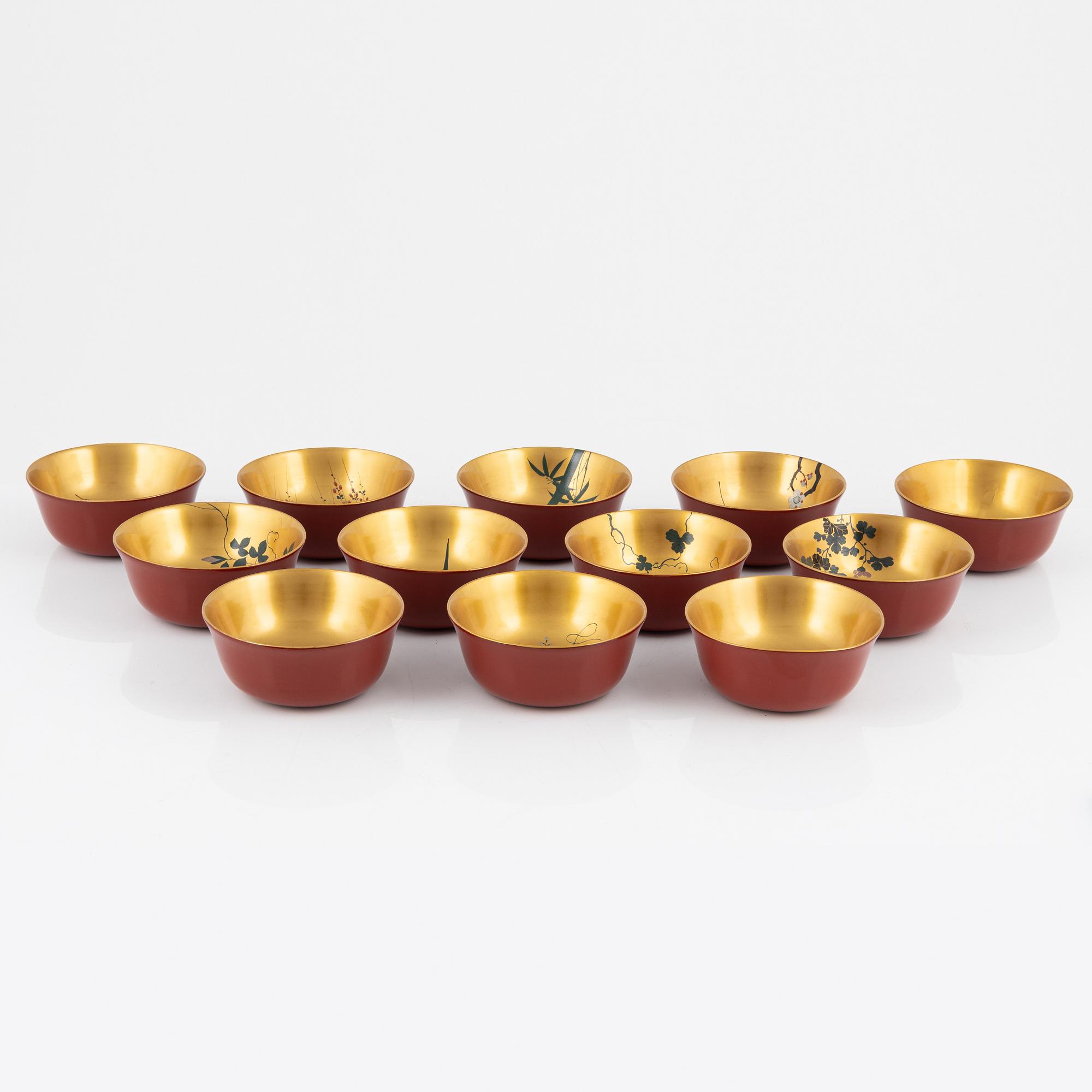 A silk clad box with twelve Japanese lacquer bowls, with dating inside the box 28/5 1930.