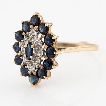 Ring 14K barn-shaped with dark sapphires and small diamonds.