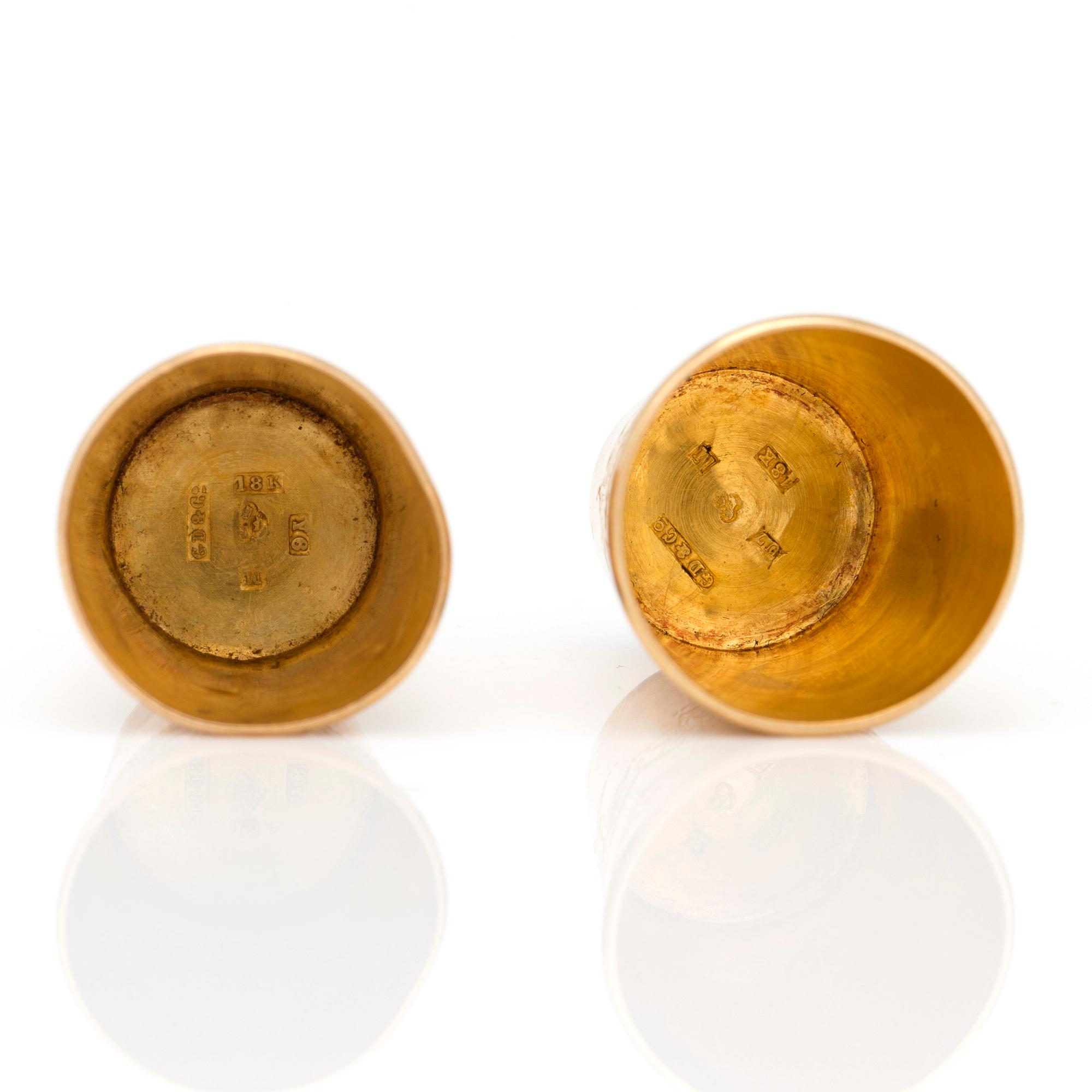 Two 18K gold thimbles with blue and lilac stones.