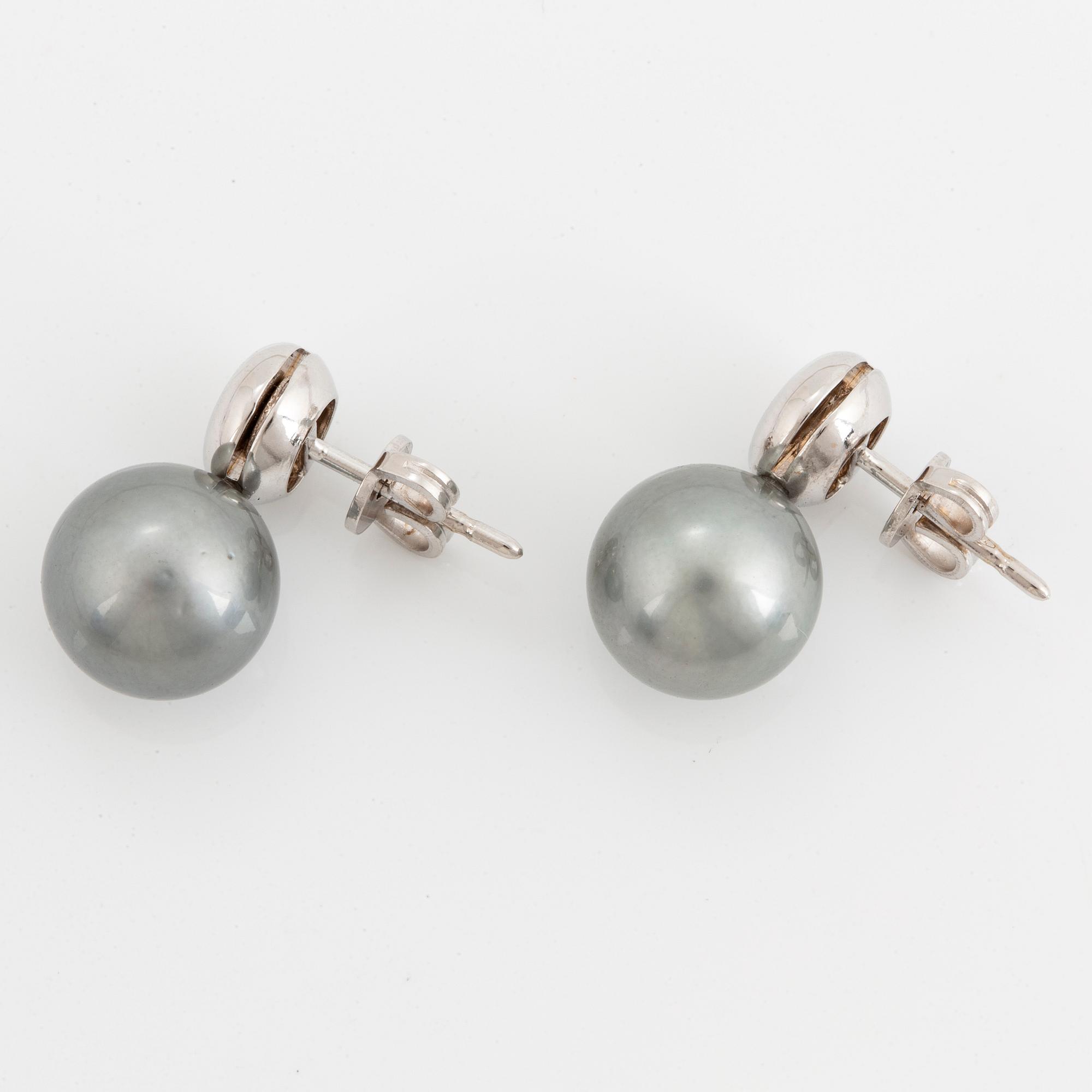 Cultured Tahiti pearl earrings with brilliant-cut diamonds.