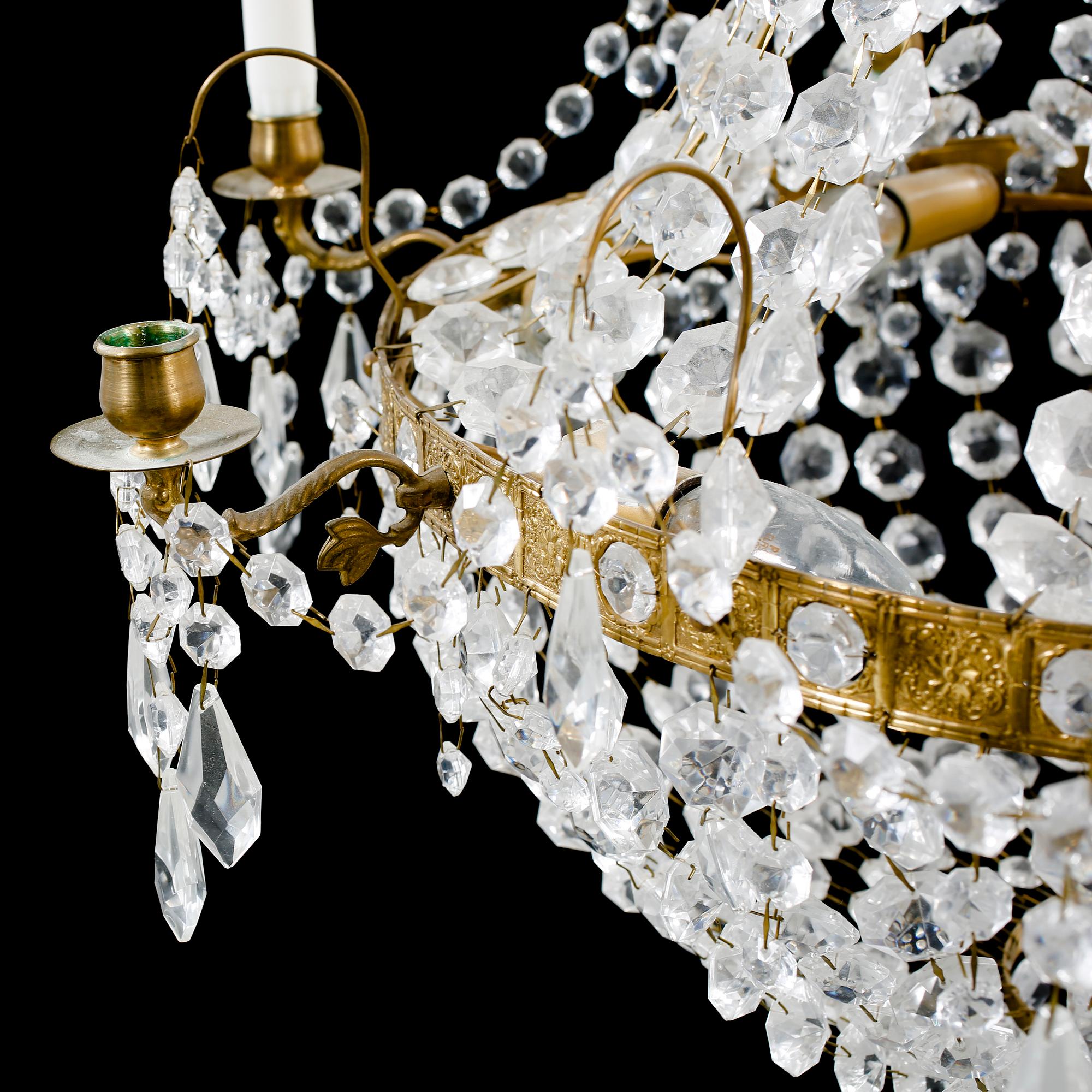 A 20th century chandelier in the Empire style. Height ca 96 cm.