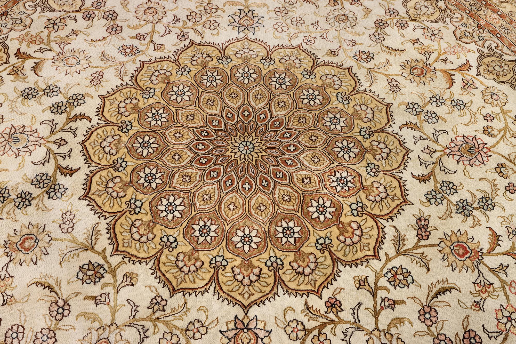 An oriental silk rug, diameter c. 216 cm.