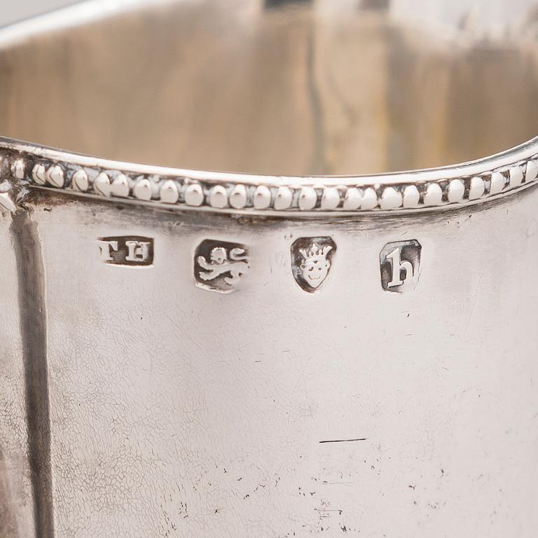 Two sterling silver milk jugs, mark of Thomas Hyde 1783 and Walter & John Barnard 1877, London.