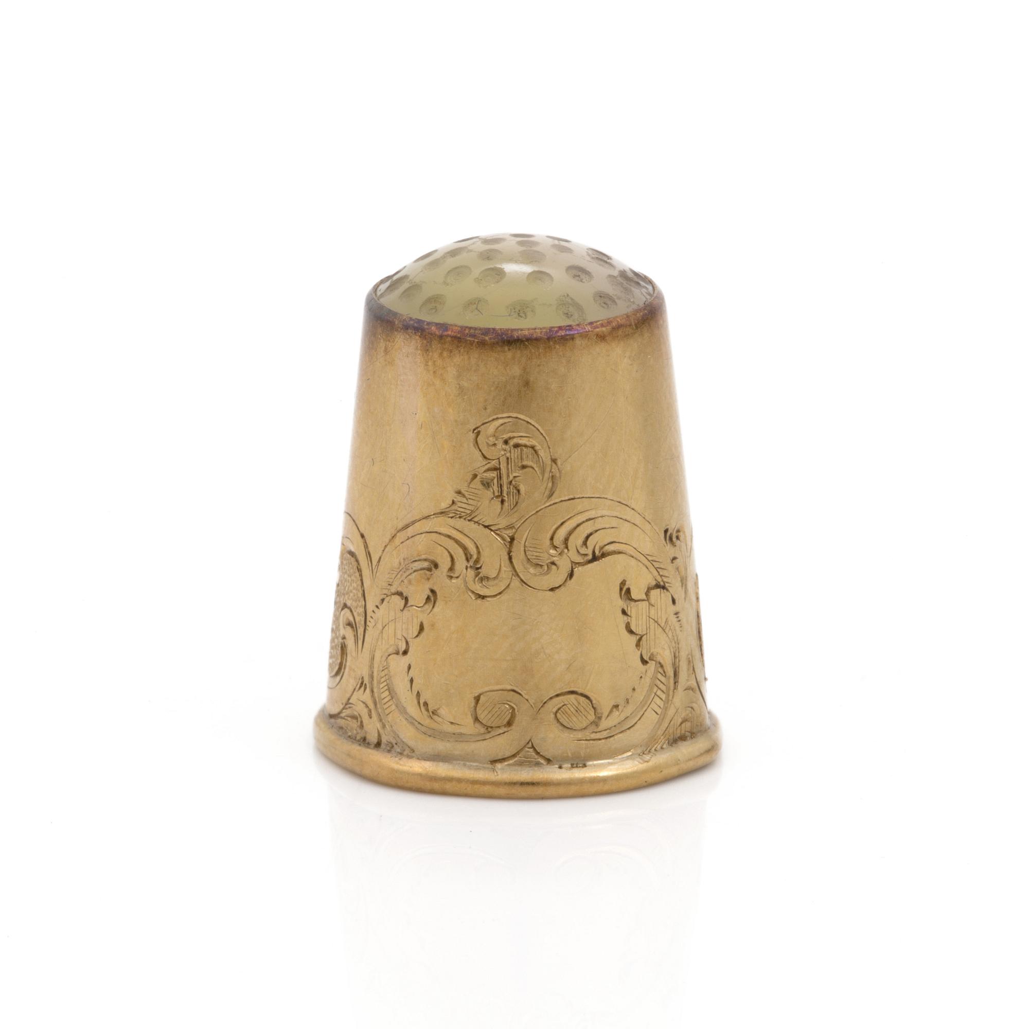 An 18K gold thimble.