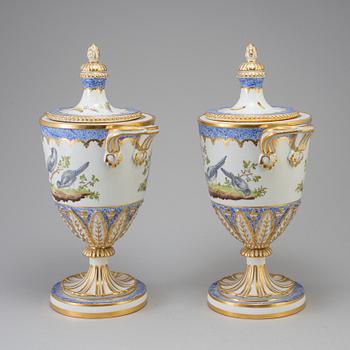 A pair of French 19th century porcelaine 
lidded vases with Sèvres style mark.