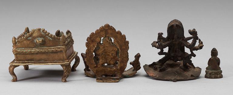 A set of three bronze figures of Buddha and a throne, India, 17/18th Century.