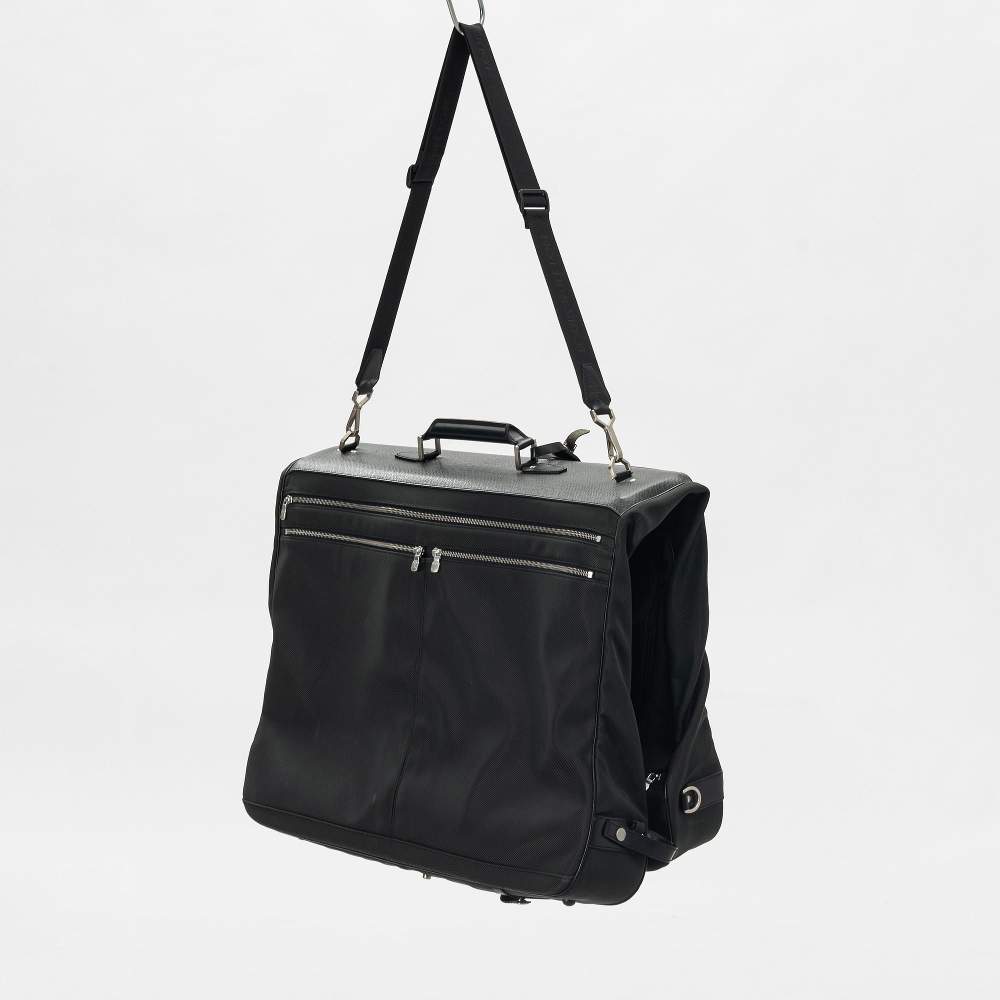 Louis Vuitton, a green canvas and Taiga garment bag.