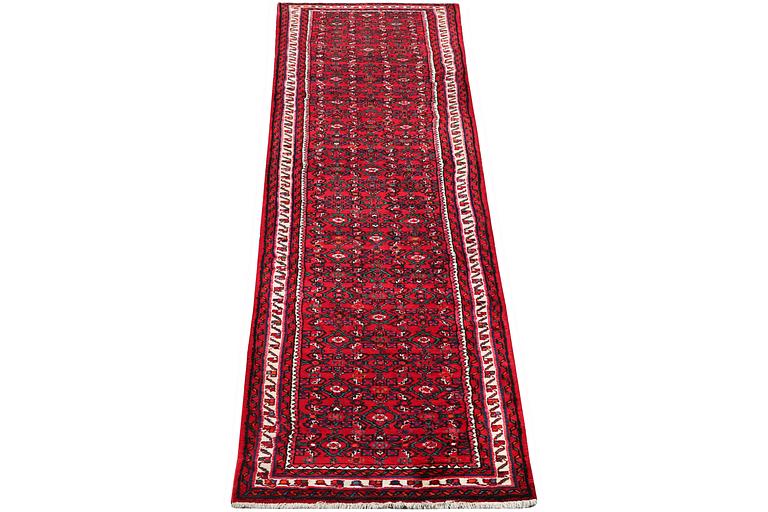 An oriental runner carpet, c. 395 x 87 cm.