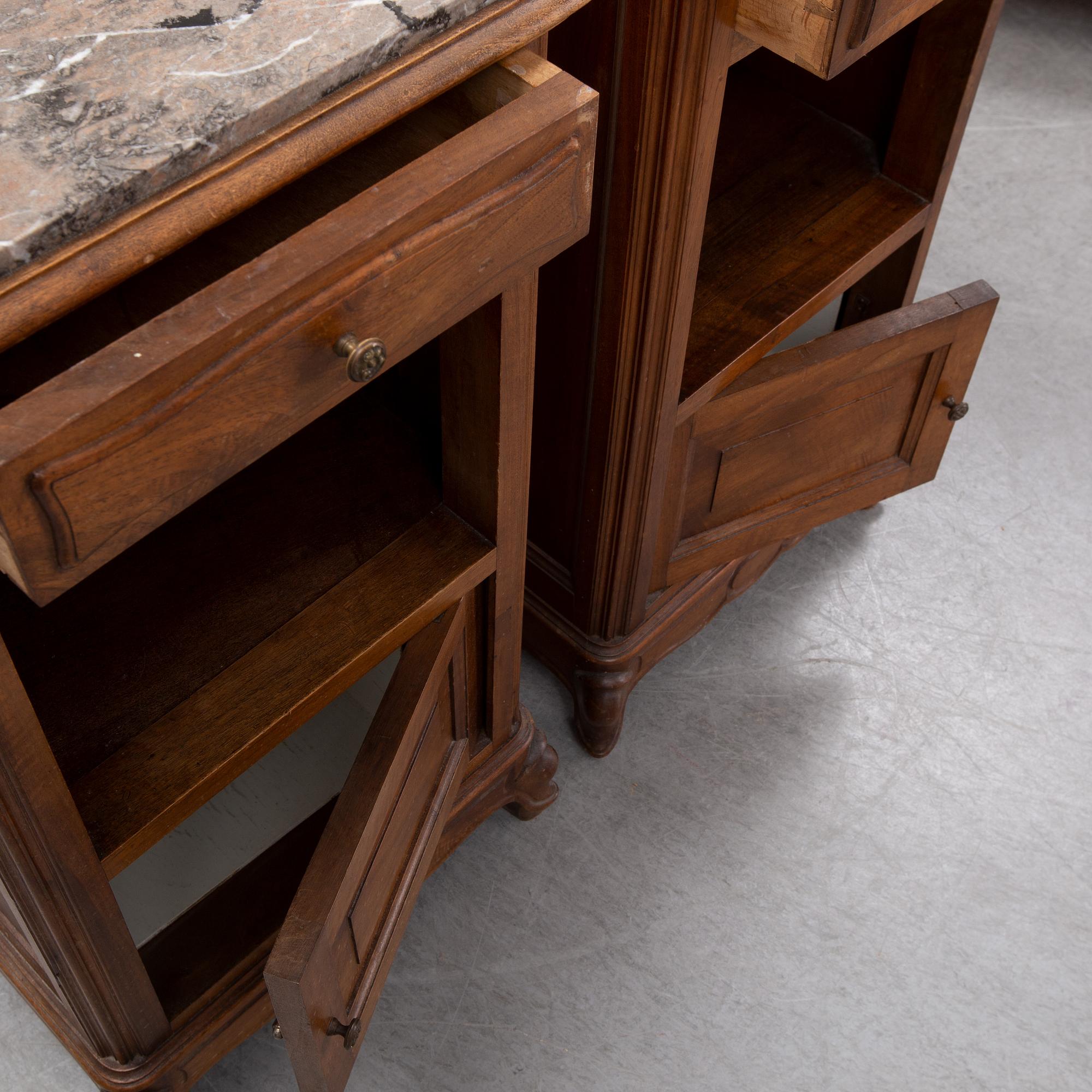 A pair of walnut marble top bedside tables, first half of the 20th Century.