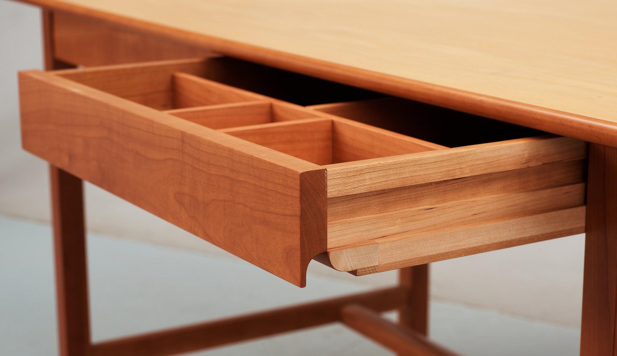 A Josef Frank ash and mahogany desk with brass fittings, by Svenskt Tenn.