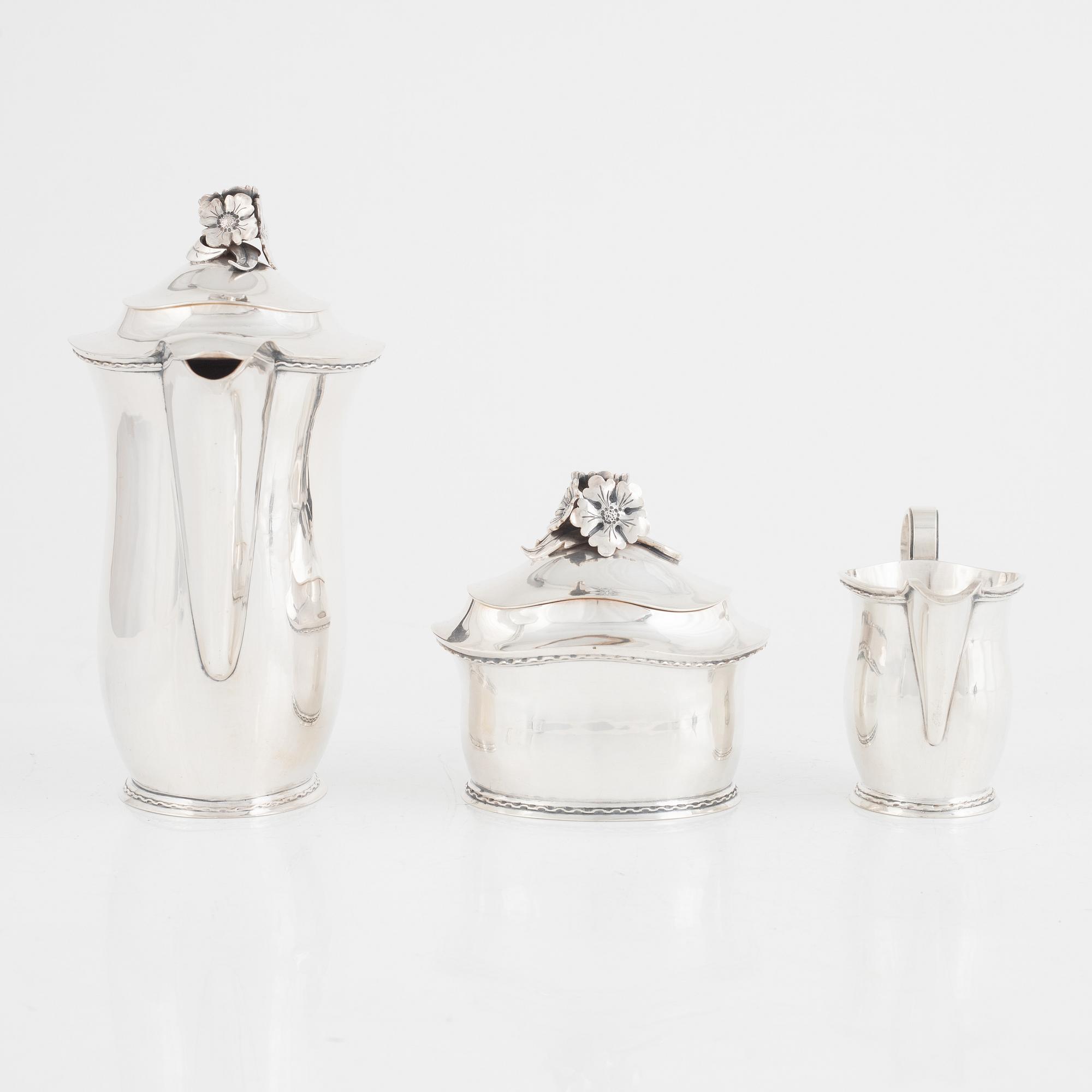A Swedish Silver Coffee Pot, Creamer and Sugar Bowl, mark of Carl Fredrik Carlman, Stockholm 1951-54.