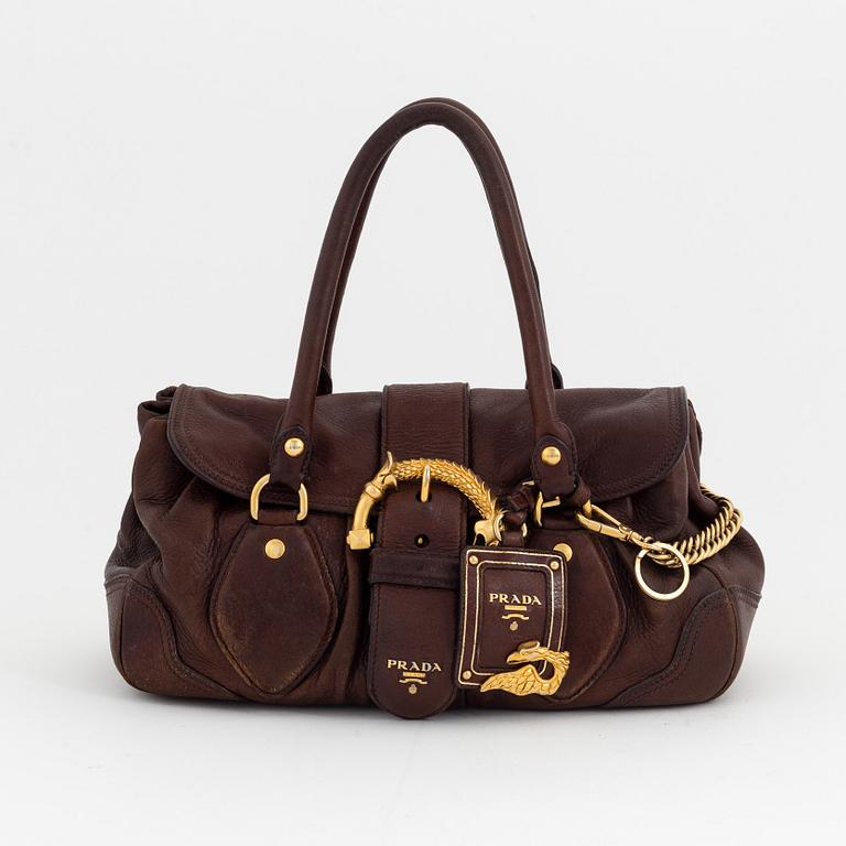 Prada, a brown leather bag.