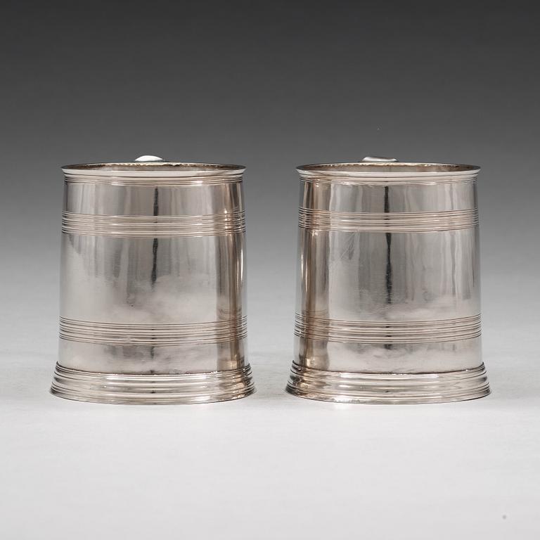 A pair of English early 18th century silver muggs, mark of John Cory, London 1704.