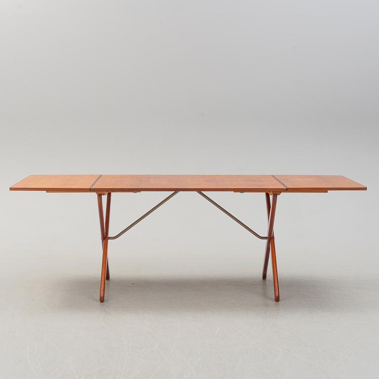 A teak veneer and stained beech dining table, mid 20th Century.