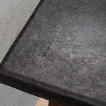 A 19th Century Baroque style table with a stone top.