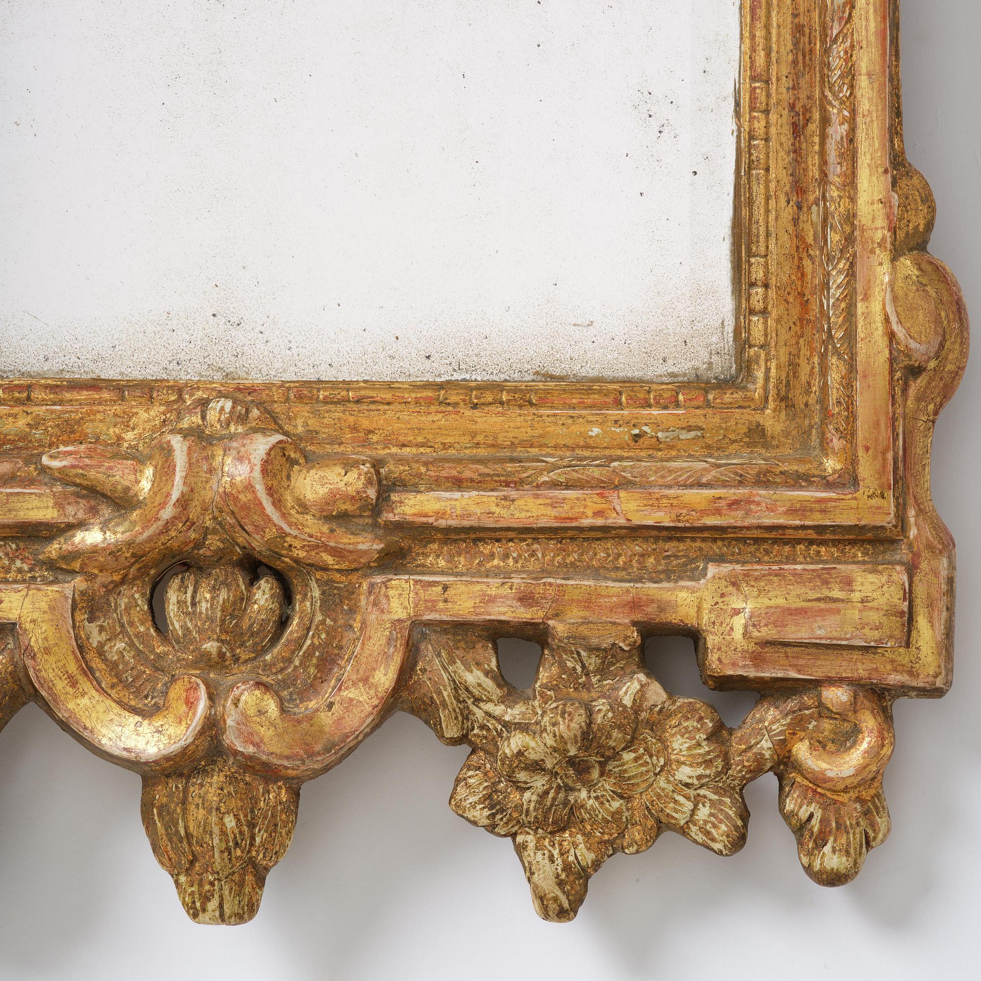 A Swedish rococo giltwood mirror, Stockholm, later part 18th century.