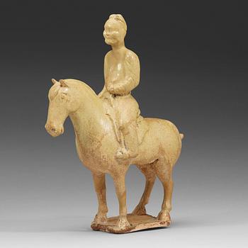 315. A yellow glazed pottery figure of a horse with its rider, Tang/Sui dynasty (581-906).