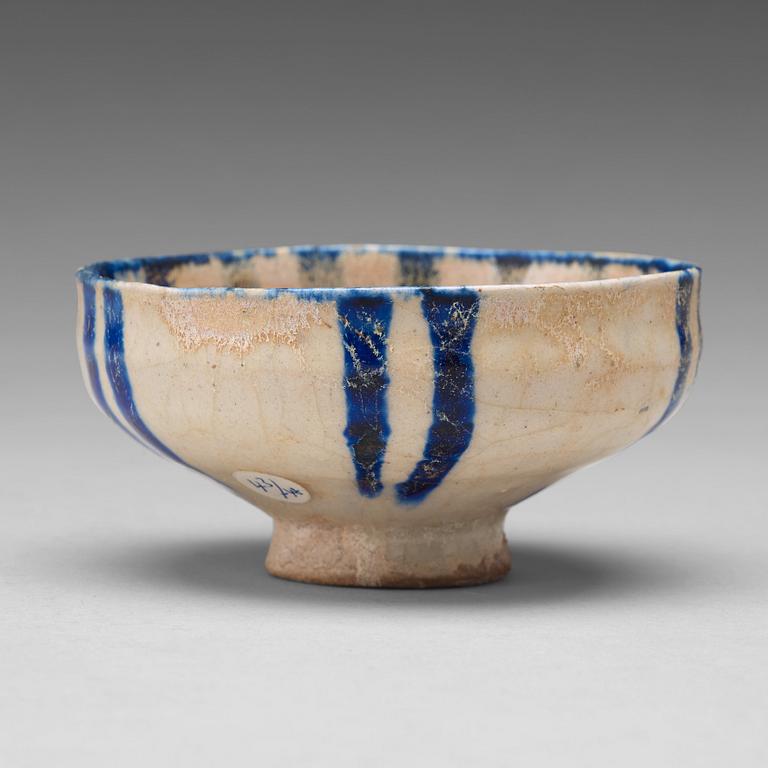 A BOWL, pottery with a white slip and underglaze blue decor, diameter ca 10 cm, Kashan, Persia/Iran early 13th century.