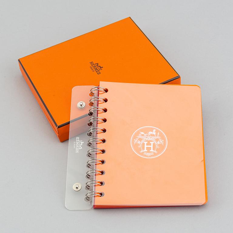 Hermès, a blue leather notebook with two scripple pads.