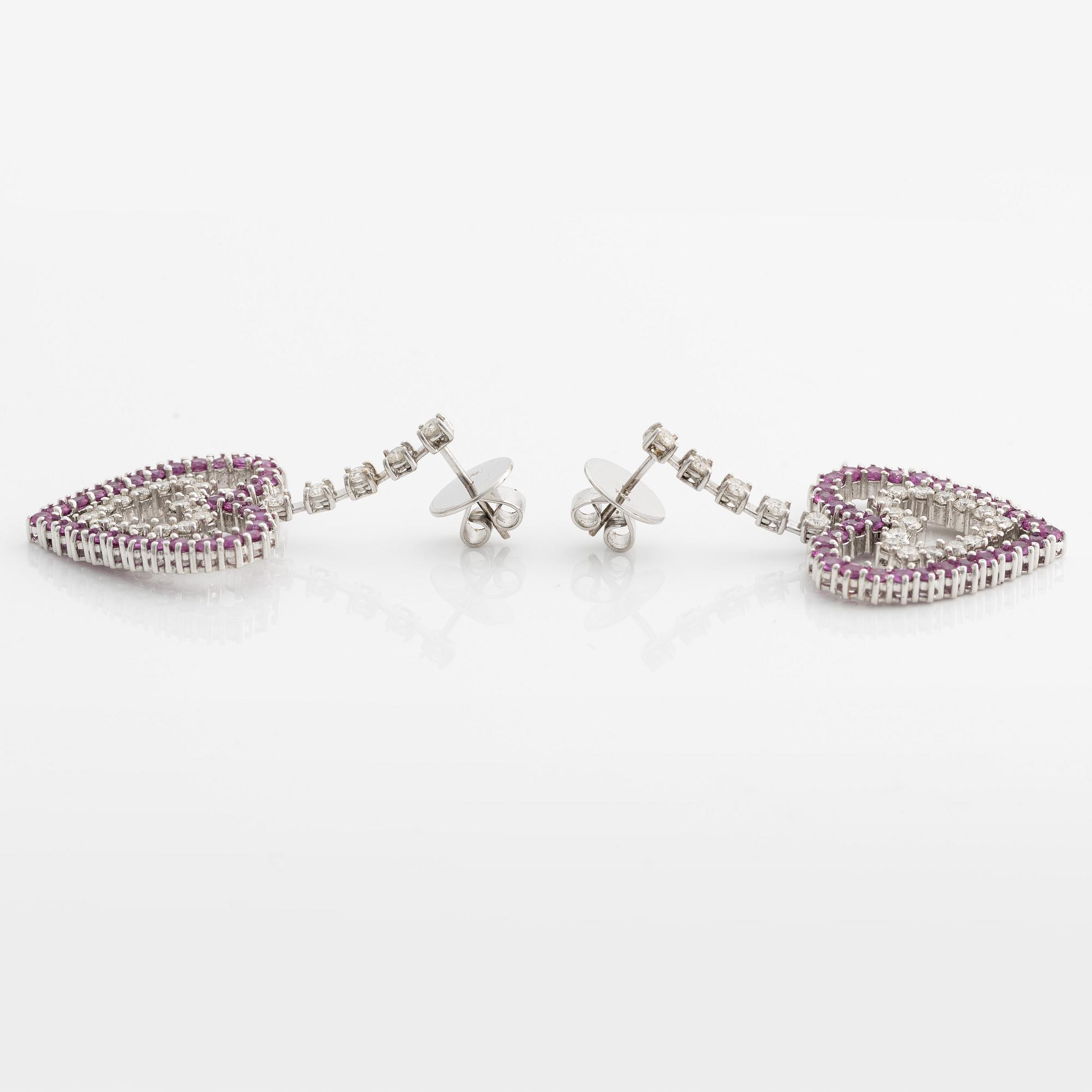 A pair of 18K gold earrings with round brilliant-cut diamonds and pink sapphires.