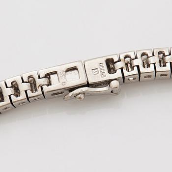 A platinum necklace set with tapered baguette-cut diamonds.