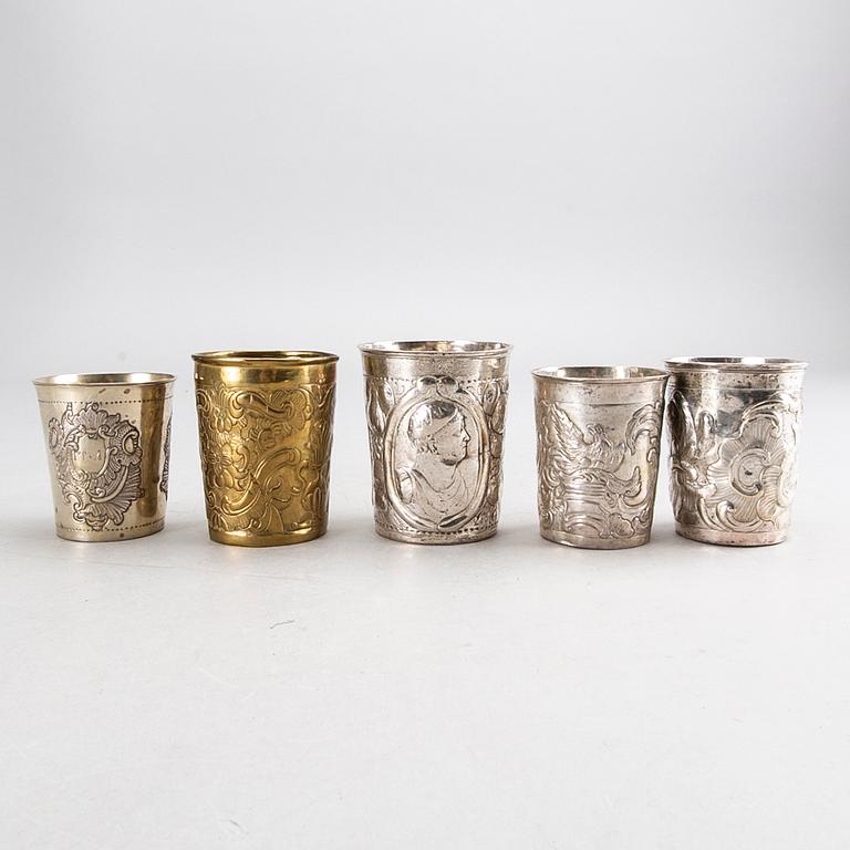 Five Russian 18th century silver and brass beakers, silver weight 292 gr, height ca 7-8,5 cm.