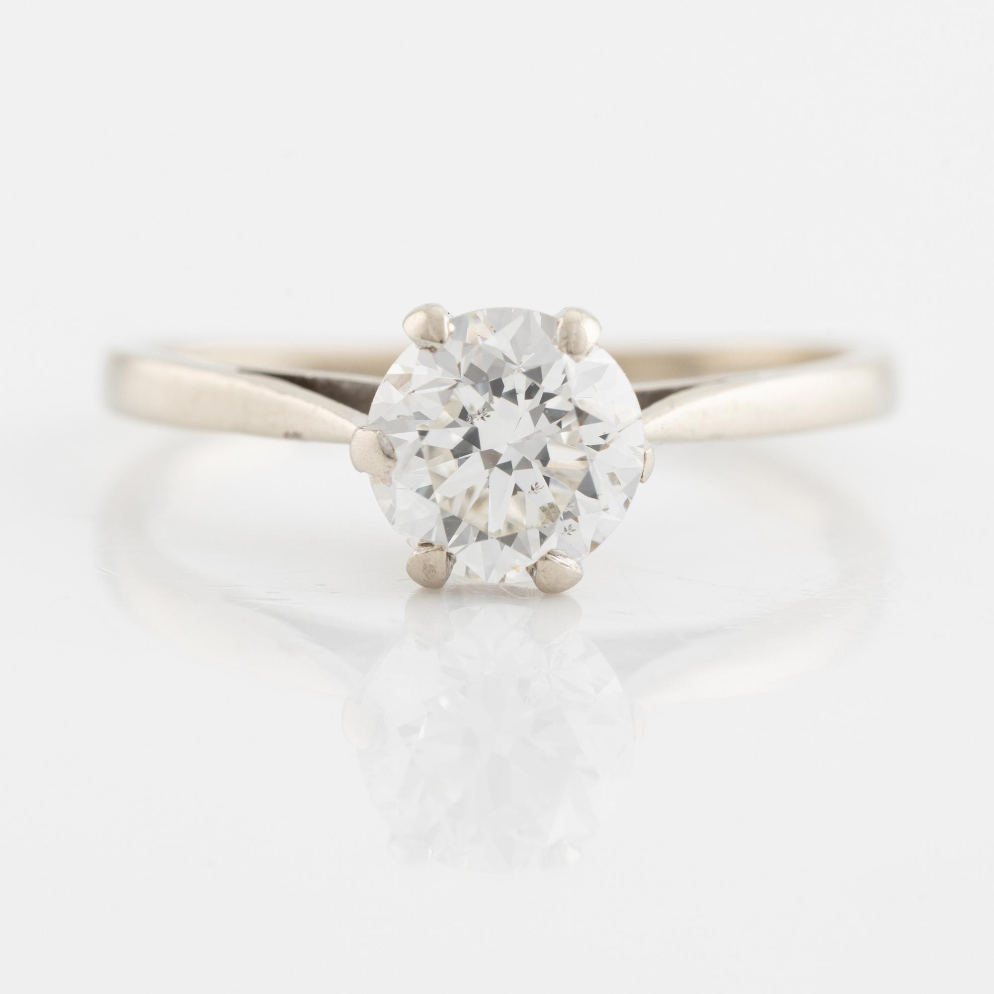 A 14K gold ring set with a round brilliant-cut diamond.