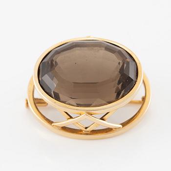 Brosch 18K guld med en fasettslipad rökkvarts.