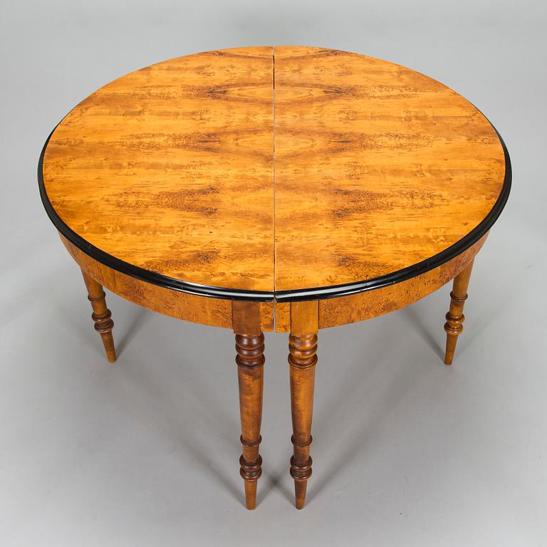 A birch veneered dining table, second half of the 19th Century.