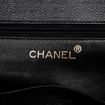 CHANEL, a black caviar leather shoulder bag with gold colored CC lock.