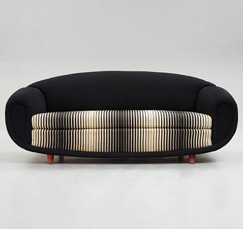 A 1940's sofa, upholstered in black and white striped fabric.