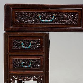 A carved hardwood desk, late Qing dynasty, circa 1900.