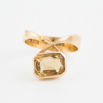 A ring set with an octagonal, step-cut citrine.