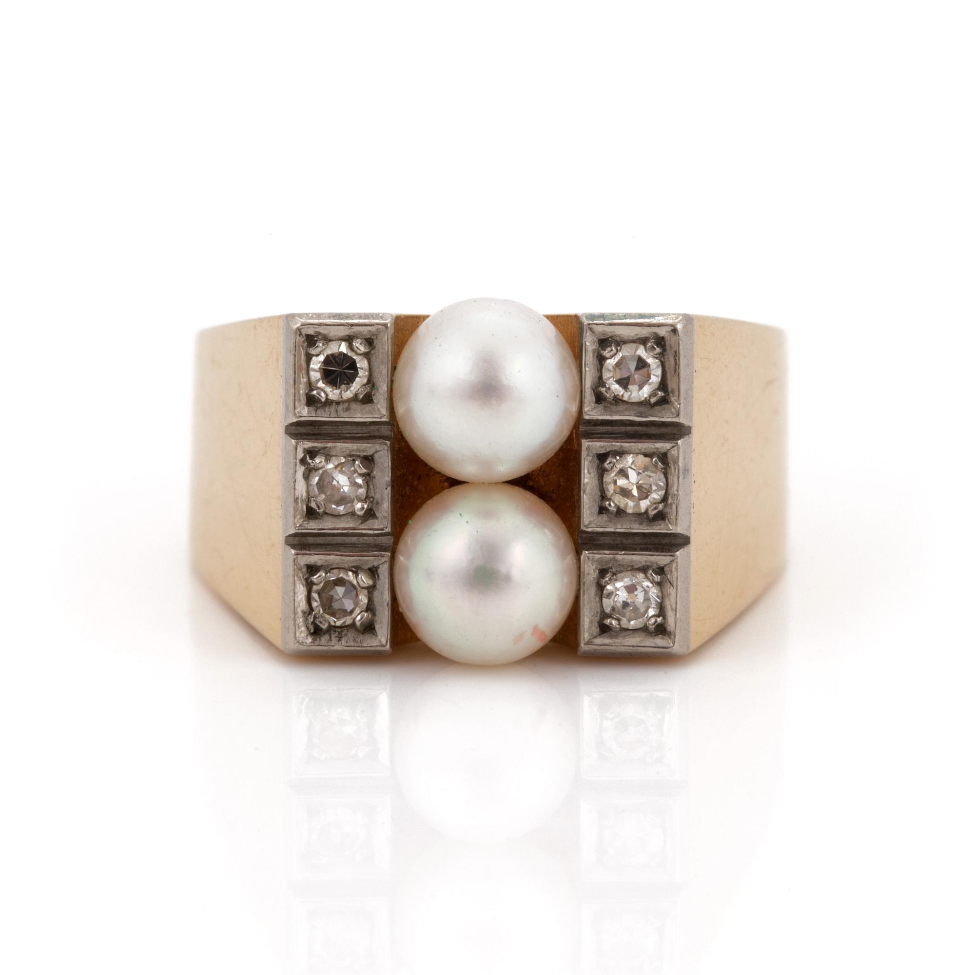 A ring set with two cultured pearls and eight-cut diamonds.