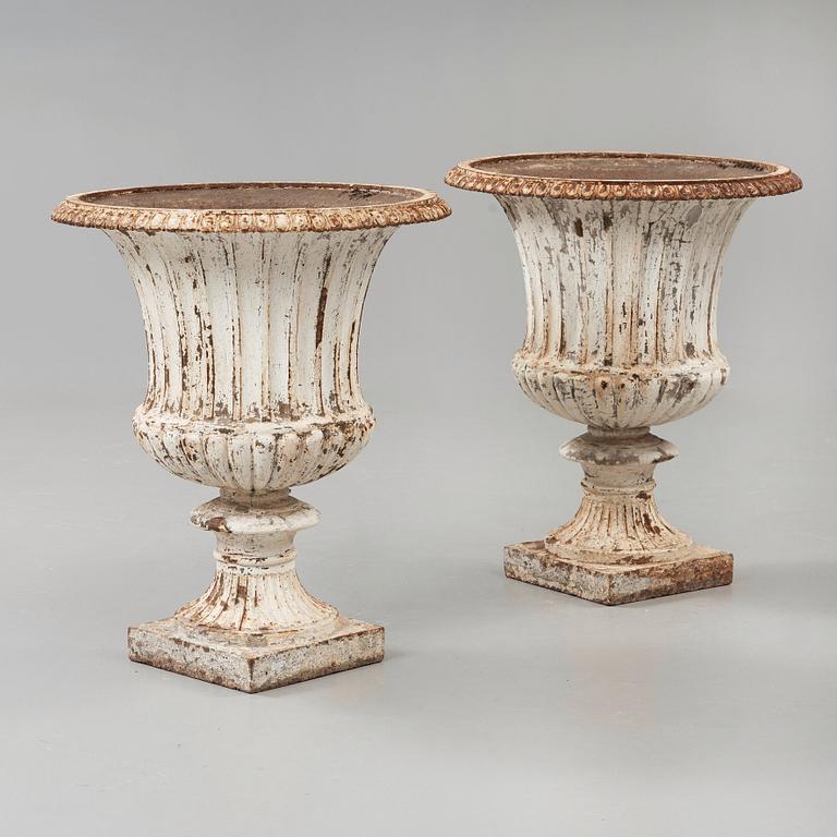 A pair of English 1860's iron garden urns.